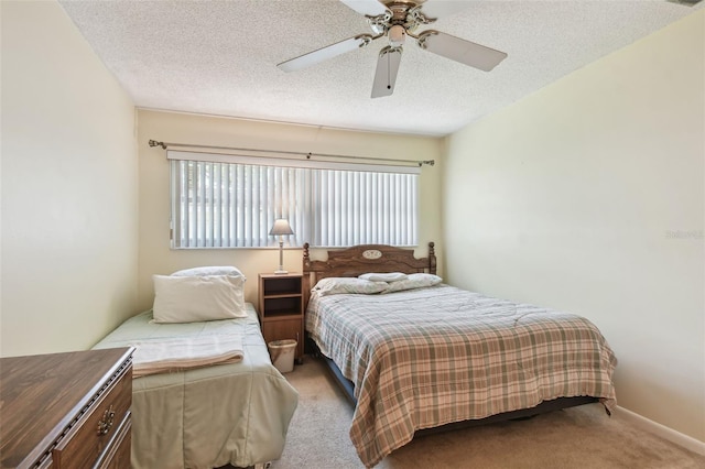 carpeted bedroom with ceiling fan and a textured ceiling