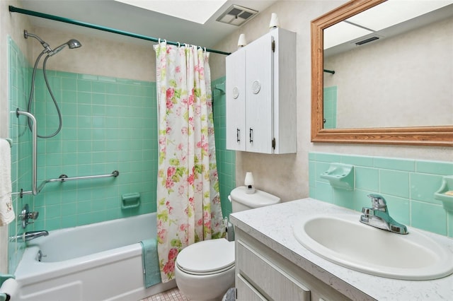 full bath with visible vents, shower / tub combo, toilet, and vanity