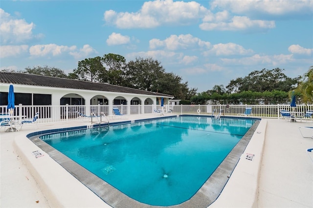 pool featuring a patio and fence