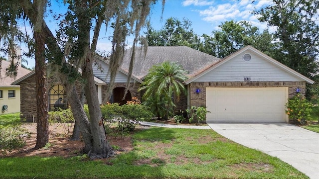 3808 Hollow Wood Dr, Valrico, FL 33594 - view of front of property with brick siding, driveway, and a garage