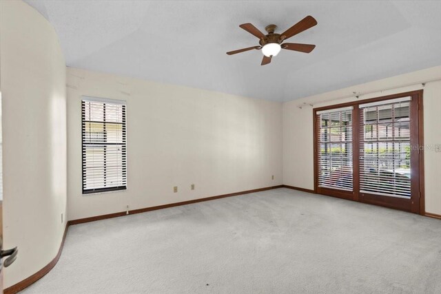 3808 Hollow Wood Dr, Valrico, FL 33594 - empty room featuring vaulted ceiling, light colored carpet, and a ceiling fan