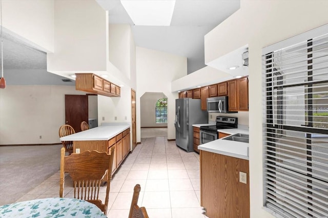 3808 Hollow Wood Dr, Valrico, FL 33594 - kitchen with stainless steel appliances, high vaulted ceiling, light countertops, light tile patterned flooring, and a peninsula