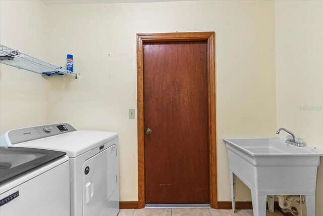 3808 Hollow Wood Dr, Valrico, FL 33594 - laundry area featuring washing machine and clothes dryer and light tile patterned floors