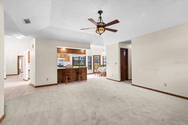 3808 Hollow Wood Dr, Valrico, FL 33594 - unfurnished living room with light colored carpet, a ceiling fan, and arched walkways