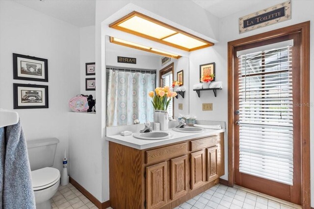 3808 Hollow Wood Dr, Valrico, FL 33594 - bathroom featuring healthy amount of natural light, double vanity, and tile patterned floors