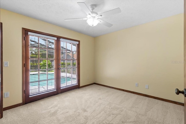 3808 Hollow Wood Dr, Valrico, FL 33594 - empty room with light carpet, french doors, a textured ceiling, and ceiling fan