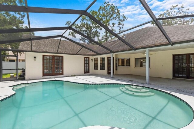 3808 Hollow Wood Dr, Valrico, FL 33594 - swimming pool featuring a patio area, glass enclosure, a ceiling fan, and french doors