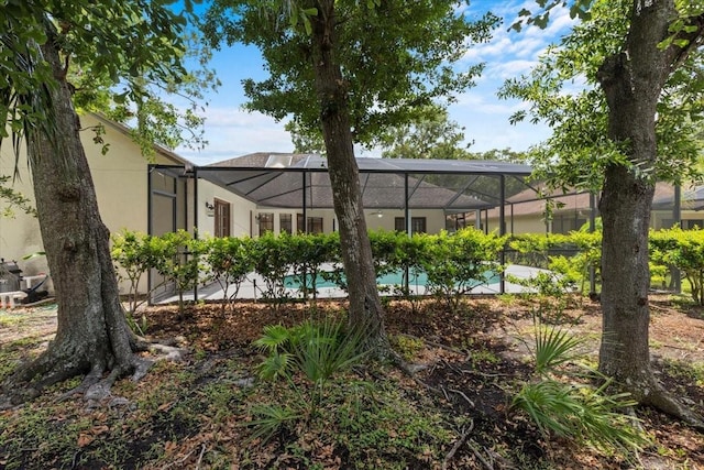 3808 Hollow Wood Dr, Valrico, FL 33594 - rear view of house with an outdoor pool, a lanai, and stucco siding
