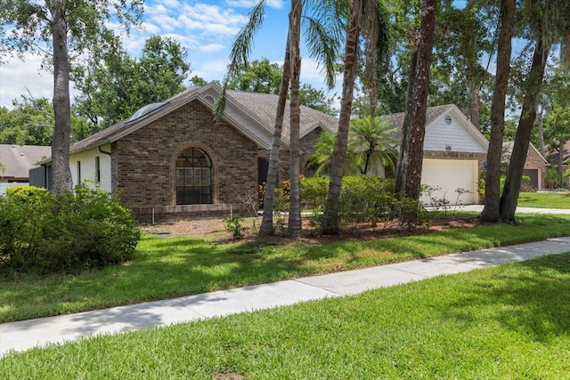 3808 Hollow Wood Dr, Valrico, FL 33594 - ranch-style house with brick siding, a front lawn, and a garage