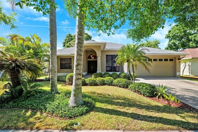 1118 Captains Way, Tarpon Springs, FL 34689 - view of front of property featuring an attached garage, concrete driveway, stucco siding, and a front yard
