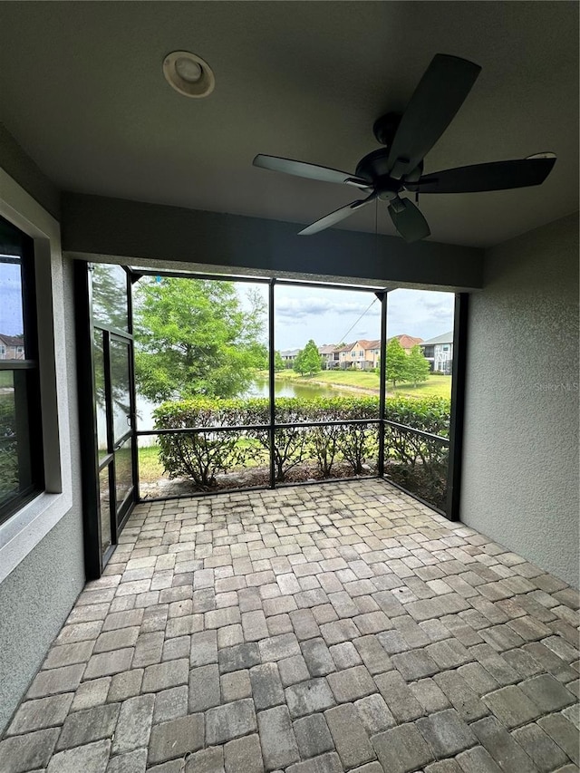 4697 Wandering Way, Wesley Chapel, FL 33544 - unfurnished sunroom featuring a ceiling fan and a water view