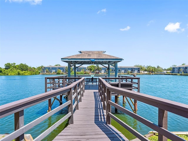 view of dock with a gazebo and a water view