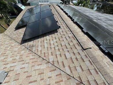 exterior details featuring a shingled roof