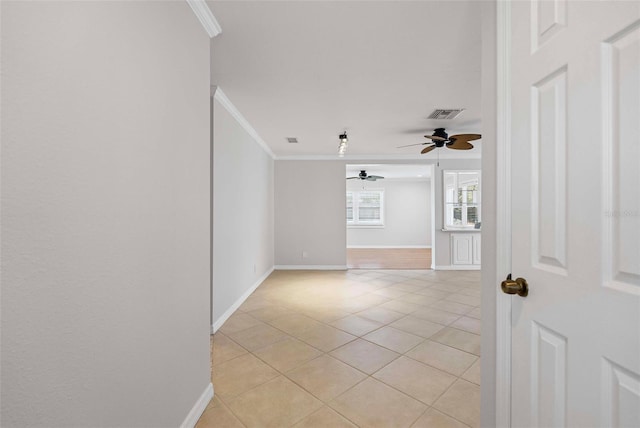 unfurnished room featuring a ceiling fan, visible vents, crown molding, light tile patterned floors, and baseboards