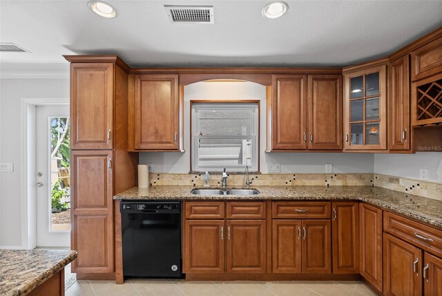 kitchen featuring visible vents, a sink, brown cabinetry, and dishwasher