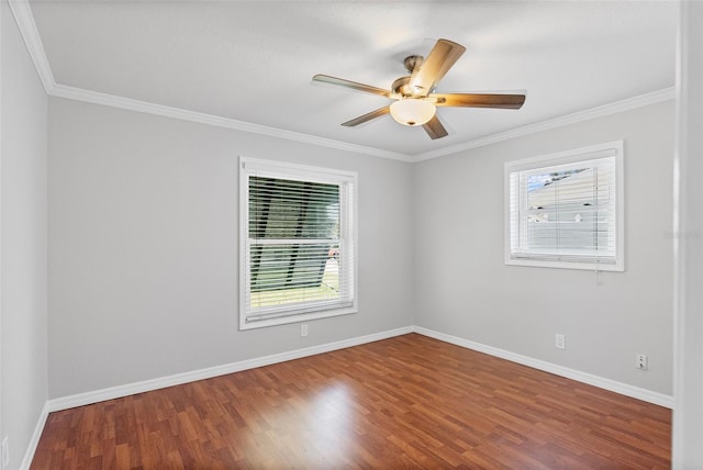 spare room with baseboards, ornamental molding, a ceiling fan, and wood finished floors
