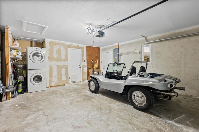 garage featuring a garage door opener, electric panel, and stacked washer / dryer