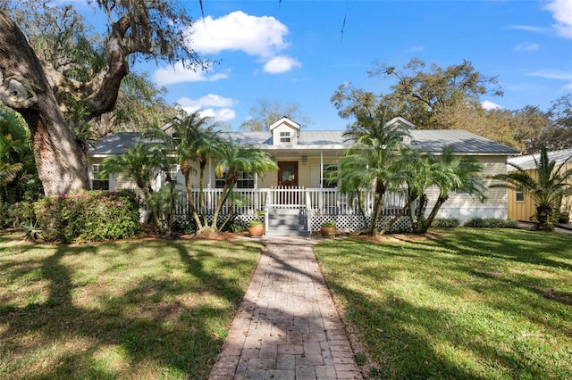 13015 Elm St, Odessa, FL 33556 - view of front facade with covered porch, a front lawn, and metal roof