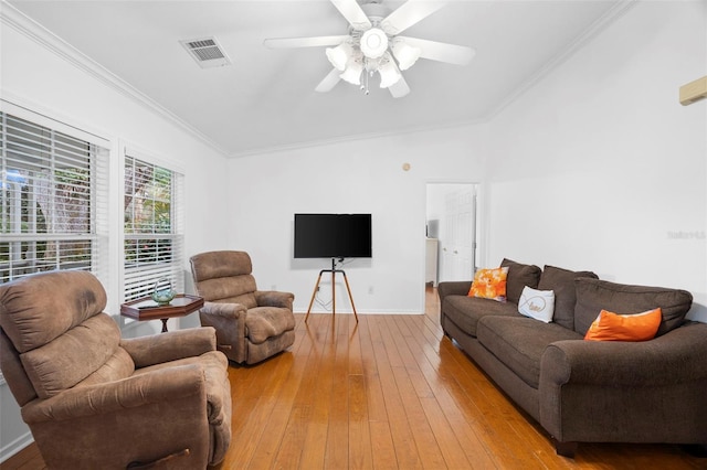 13015 Elm St, Odessa, FL 33556 - living room with visible vents, ornamental molding, ceiling fan, baseboards, and light wood-type flooring