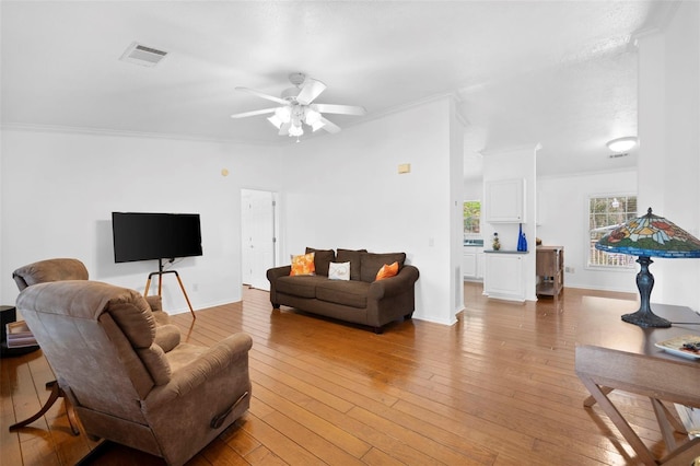 13015 Elm St, Odessa, FL 33556 - living room with visible vents, a ceiling fan, light wood finished floors, and crown molding
