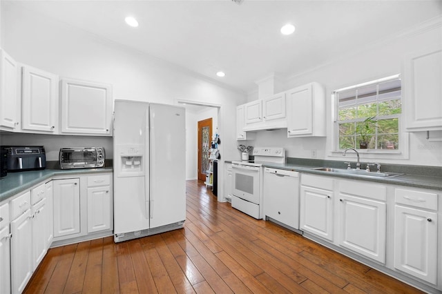 13015 Elm St, Odessa, FL 33556 - kitchen with white appliances, a toaster, ornamental molding, a sink, and white cabinetry