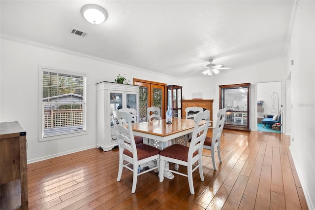 13015 Elm St, Odessa, FL 33556 - dining space featuring a ceiling fan, visible vents, hardwood / wood-style flooring, and crown molding