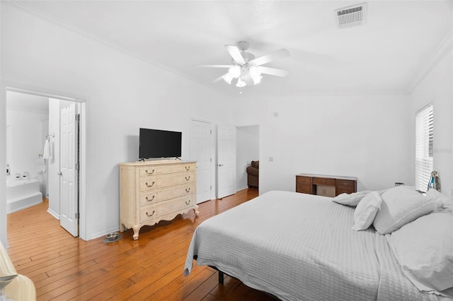 13015 Elm St, Odessa, FL 33556 - bedroom with connected bathroom, ceiling fan, light wood-type flooring, crown molding, and visible vents