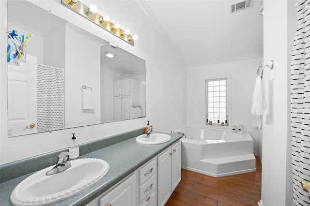 13015 Elm St, Odessa, FL 33556 - full bathroom featuring wood finished floors, visible vents, crown molding, and a sink