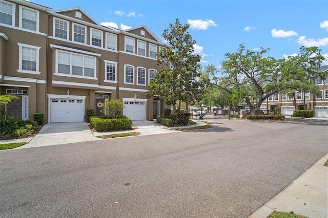 3056 Pointeview Dr, Tampa, FL 33611 - multi unit property featuring concrete driveway, a garage, stucco siding, and a residential view