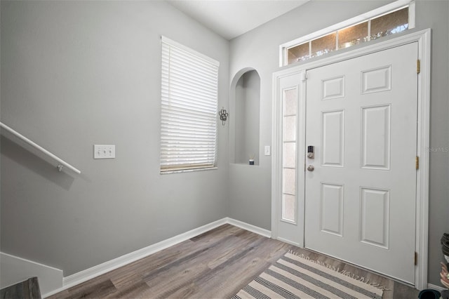 3056 Pointeview Dr, Tampa, FL 33611 - foyer with baseboards, arched walkways, and wood finished floors