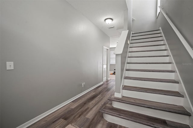 3056 Pointeview Dr, Tampa, FL 33611 - staircase with a textured ceiling, baseboards, and wood finished floors