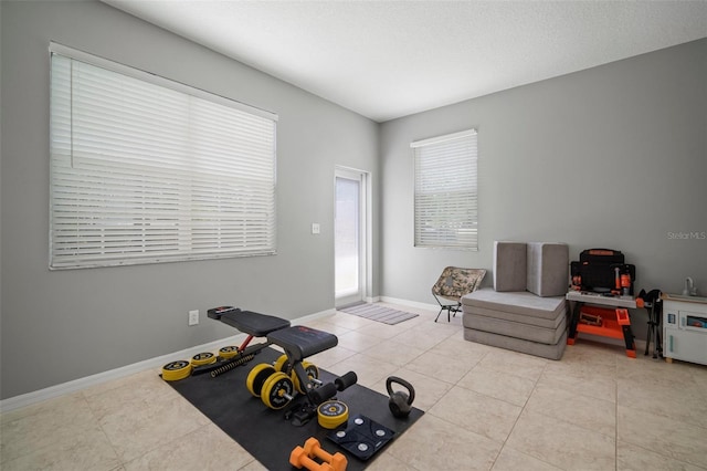 3056 Pointeview Dr, Tampa, FL 33611 - exercise area with baseboards and light tile patterned floors