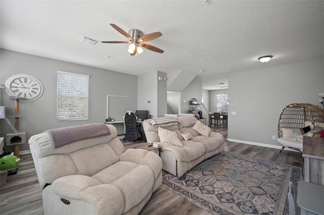 3056 Pointeview Dr, Tampa, FL 33611 - living area featuring a ceiling fan, a textured ceiling, visible vents, wood finished floors, and baseboards