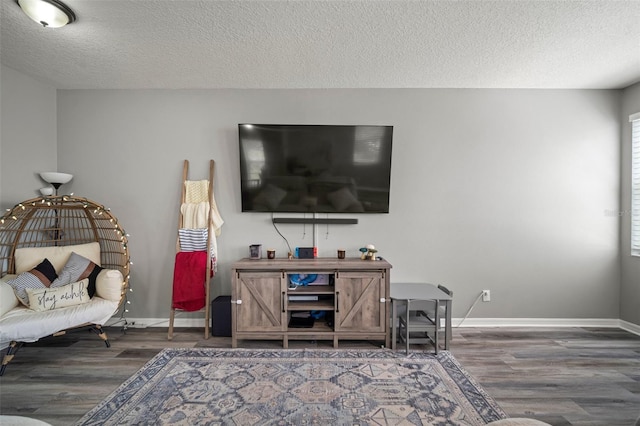 3056 Pointeview Dr, Tampa, FL 33611 - living area with a textured ceiling, baseboards, and wood finished floors