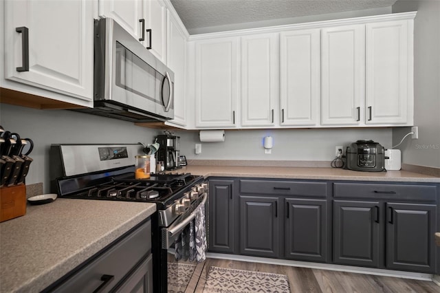 3056 Pointeview Dr, Tampa, FL 33611 - kitchen featuring white cabinets, appliances with stainless steel finishes, and gray cabinetry