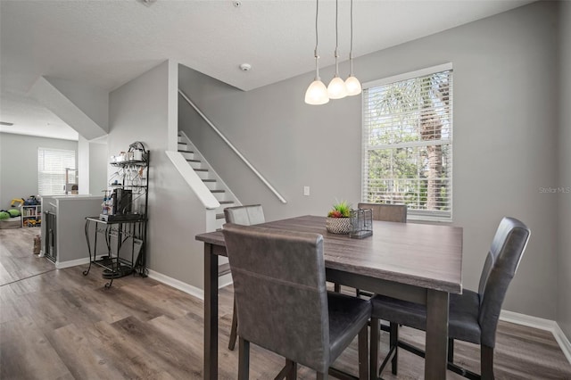 3056 Pointeview Dr, Tampa, FL 33611 - dining room with baseboards, stairs, and wood finished floors
