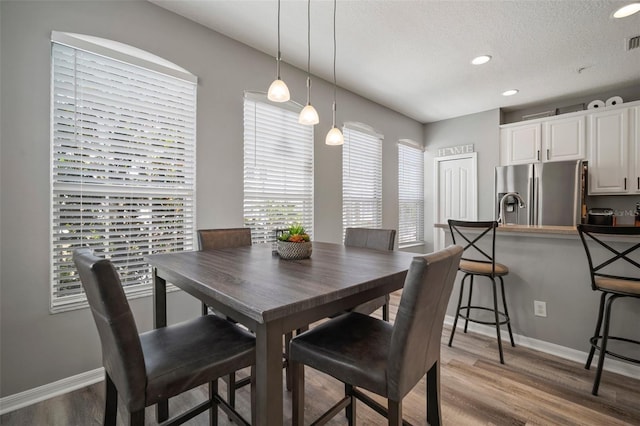 3056 Pointeview Dr, Tampa, FL 33611 - dining area with light wood-style floors, baseboards, recessed lighting, and visible vents