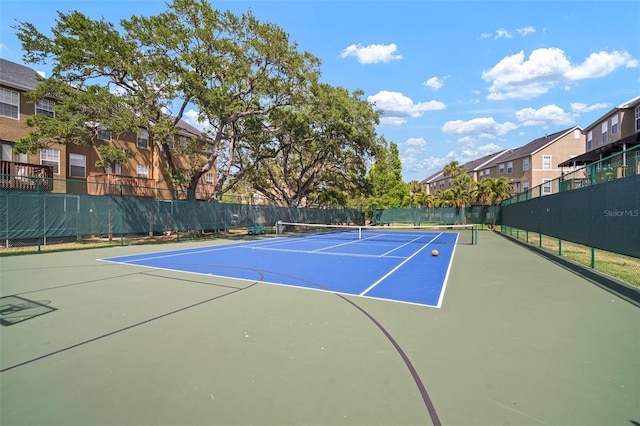 3056 Pointeview Dr, Tampa, FL 33611 - view of sport court with fence, community basketball court, and a residential view