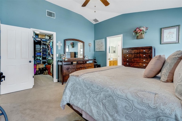 bedroom with visible vents, a spacious closet, vaulted ceiling, and carpet floors
