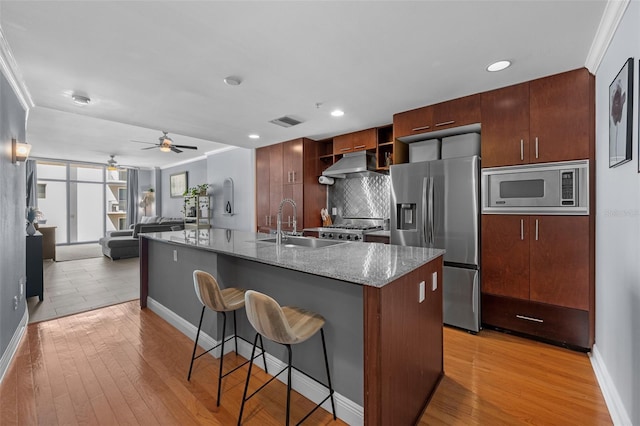 1120 E Kennedy Blvd Unit 1228, Tampa, FL 33602 - kitchen featuring stainless steel appliances, a sink, a ceiling fan, a kitchen bar, and baseboards