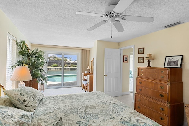 4333 48th Ave S, Saint Petersburg, FL 33711 - carpeted bedroom with visible vents, access to exterior, a ceiling fan, and a textured ceiling