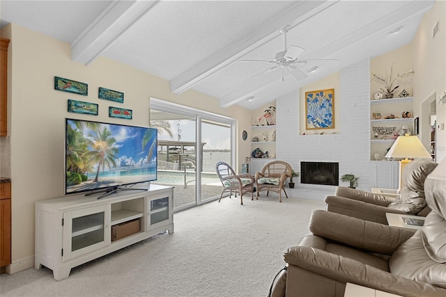 4333 48th Ave S, Saint Petersburg, FL 33711 - living area with ceiling fan, vaulted ceiling with beams, light colored carpet, and a fireplace
