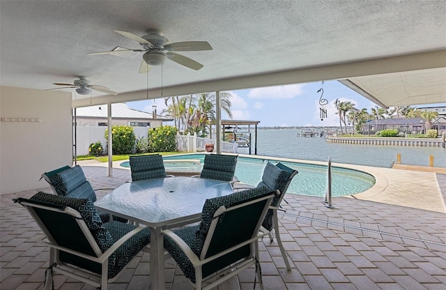 4333 48th Ave S, Saint Petersburg, FL 33711 - view of patio / terrace with a fenced in pool, fence, ceiling fan, and a water view