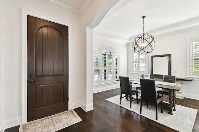 dining area featuring ornamental molding, a notable chandelier, dark wood-style flooring, and baseboards