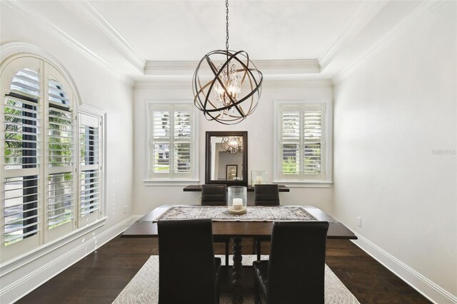 dining room with dark wood-style flooring, a chandelier, a tray ceiling, and baseboards