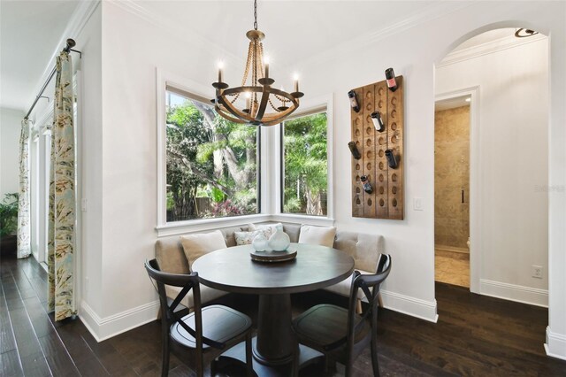 dining space with wood finished floors, a healthy amount of sunlight, a notable chandelier, and baseboards