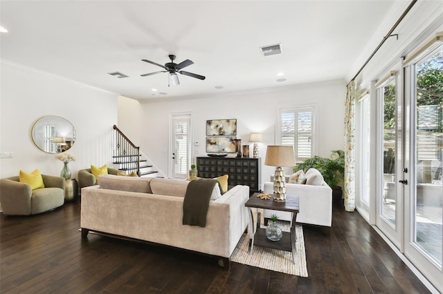 living area featuring visible vents, ceiling fan, hardwood / wood-style flooring, and ornamental molding