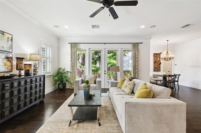 living area with visible vents, a healthy amount of sunlight, and crown molding