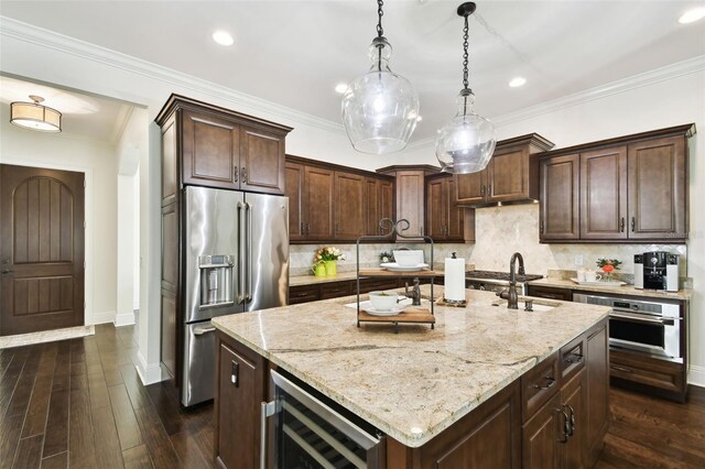 kitchen featuring a sink, appliances with stainless steel finishes, baseboards, light stone countertops, and wine cooler