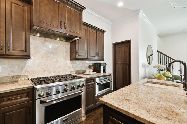 kitchen featuring crown molding, a sink, stainless steel appliances, light stone countertops, and ventilation hood